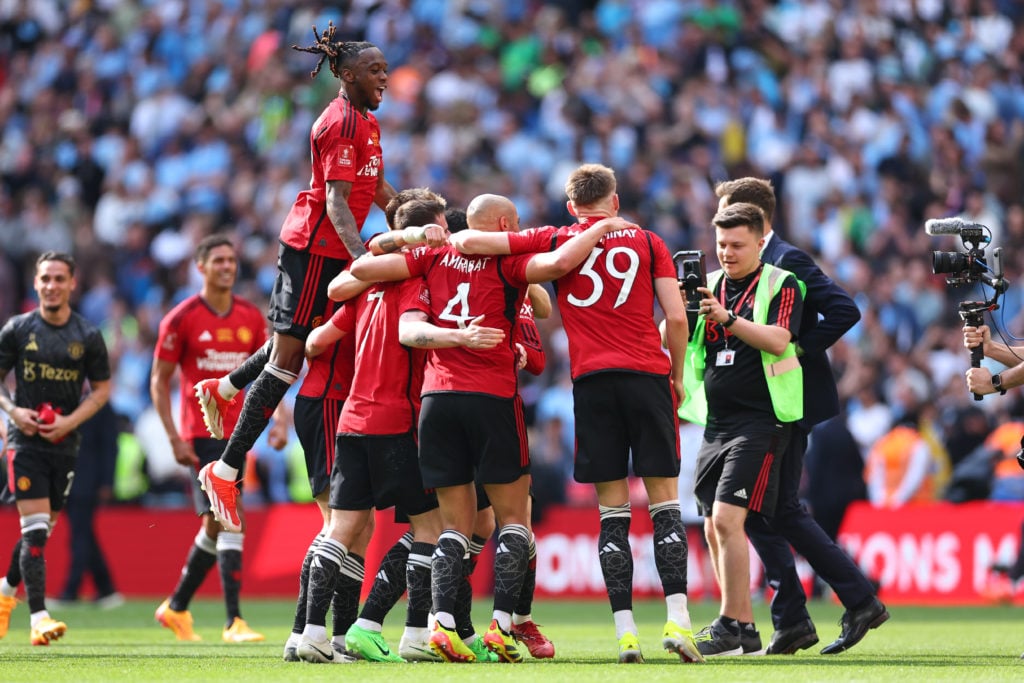 Aaron Wan-Bissaka of Manchester United jumps on his teammates at full time as Manchester United win the 2024 Emirates FA Cup during the Emirates FA...