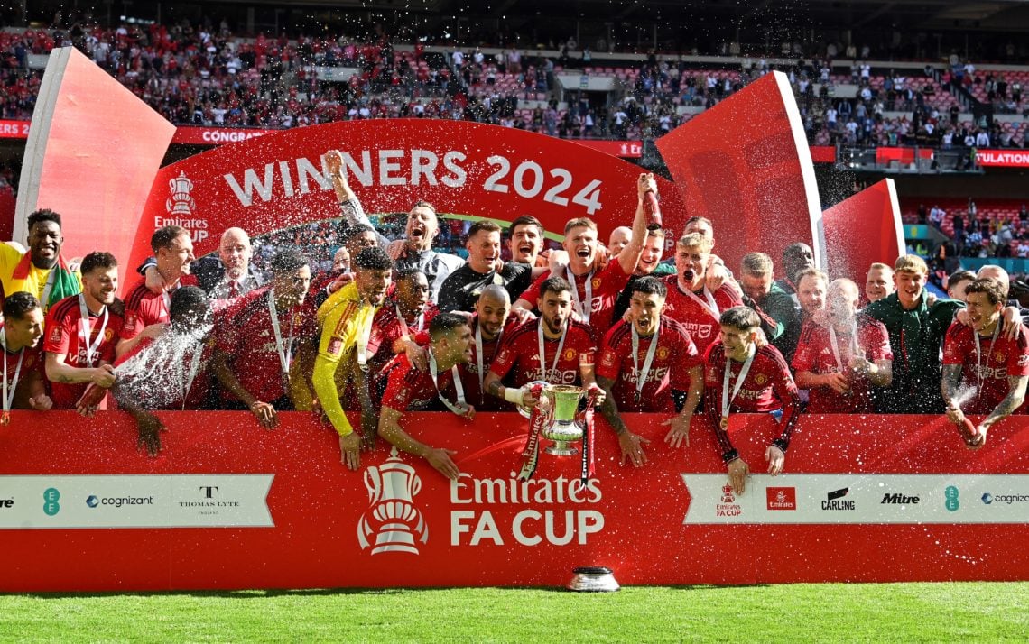 Manchester United's Portuguese midfielder #08 Bruno Fernandes  lifts the trophy to celebrate their victory at the end of the English FA Cup final f...