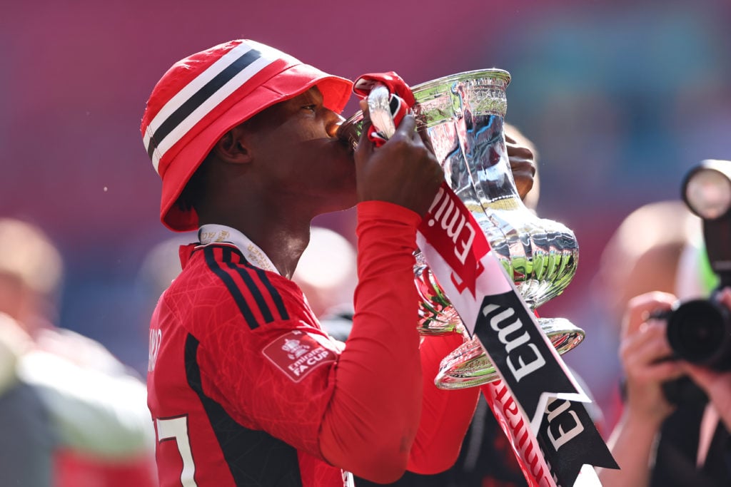 Kobbie Mainoo of Manchester United kisses the FA Cup Trophy at full time as Manchester United win the 2024 Emirates FA Cup during the Emirates FA C...