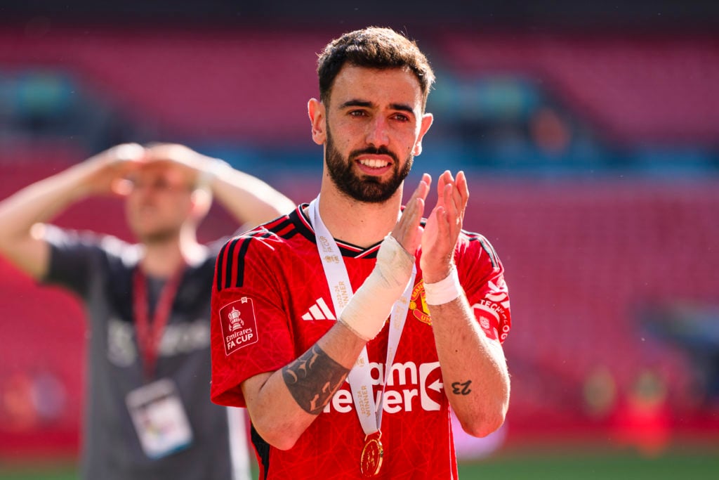 Bruno Fernandes of Manchester United celebrates with his teammates and fans after winning Manchester City during the Emirates FA Cup Final match be...