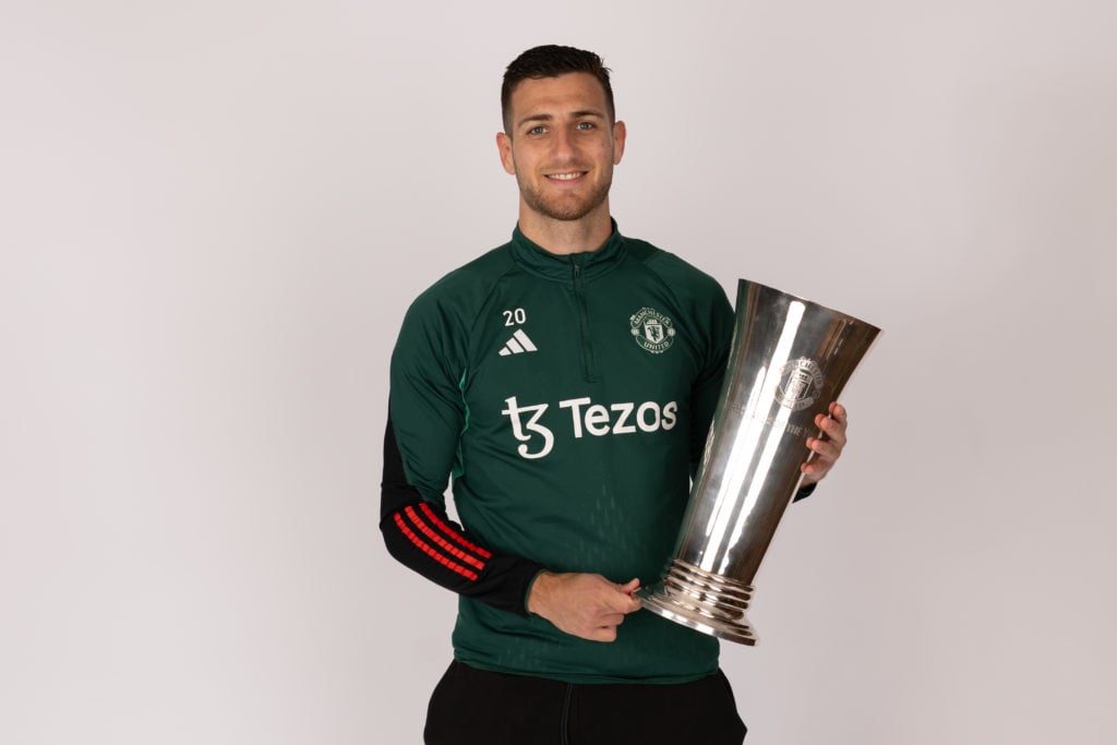 Manchester United's Diogo Dalot poses with the Player of the Year award at the Carrington Training Ground on May 23, 2024 in Manchester, England...