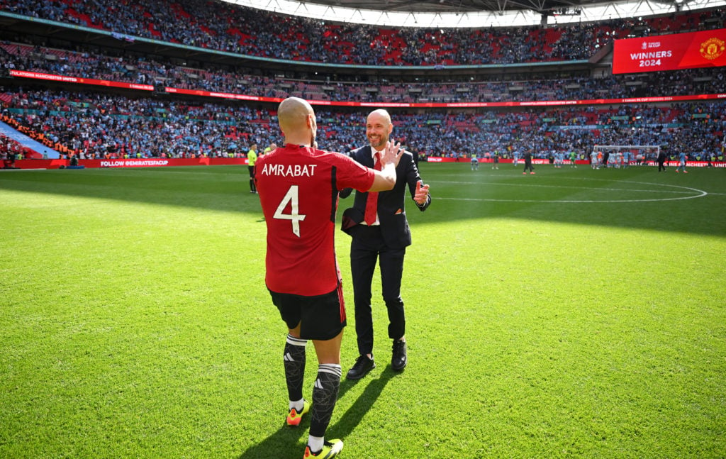 Erik ten Hag, Manager of Manchester United, interacts with Sofyan Amrabat of Manchester United during the Emirates FA Cup Final match between Manch...