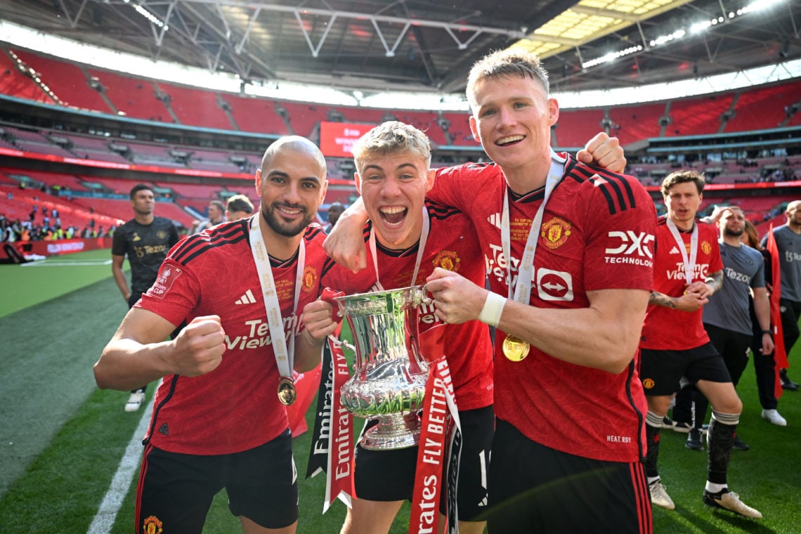 Sofyan Amrabat, Rasmus Hojlund and Scott McTominay of Manchester United celebrates with the Emirates FA Cup Trophy after his team's victory after t...