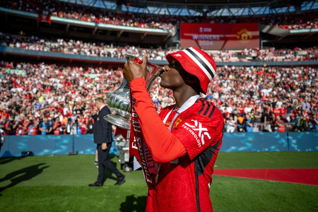 Kobbie Mainoo of Manchester United celebrates with the Emirates FA Cup trophy after winning the Emirates FA Cup Final match between Manchester City...