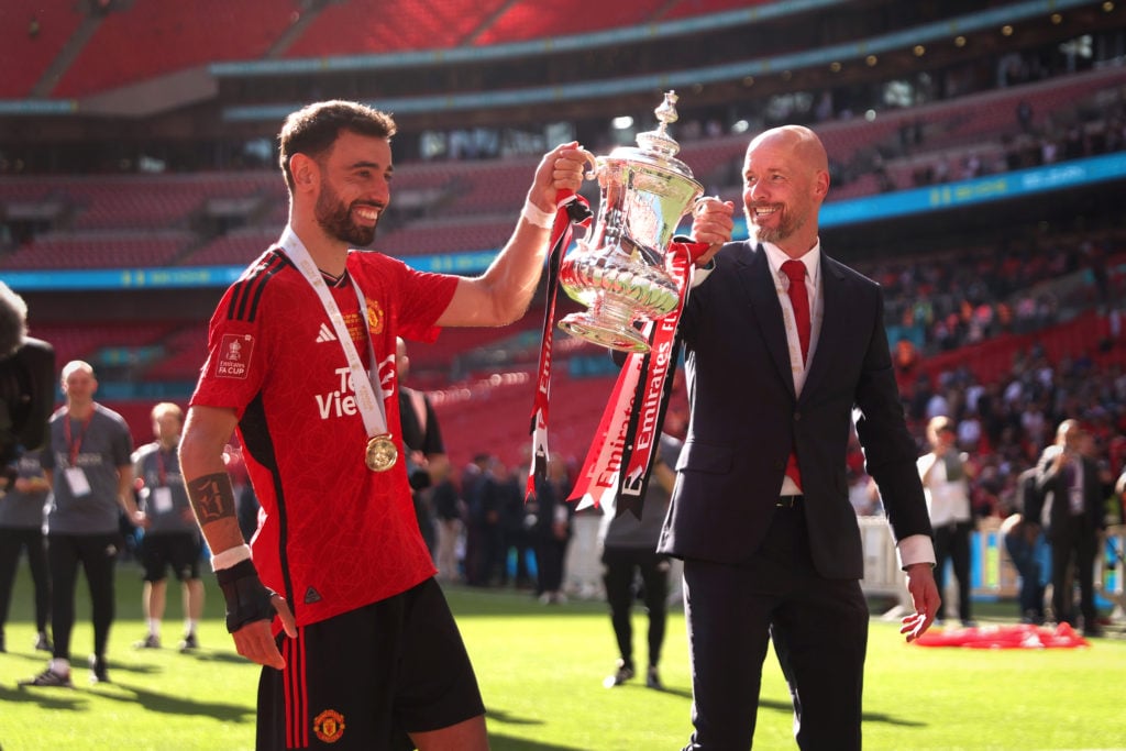 Manchester United manager Erik ten Hag and Bruno Fernandes celebrate with the trophy during the Emirates FA Cup Final match between Manchester ...