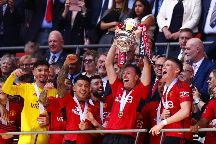 Jonny Evans of Manchester United lifts the trophy among team mates during the Emirates FA Cup Final match between Manchester City and Manchester Un...