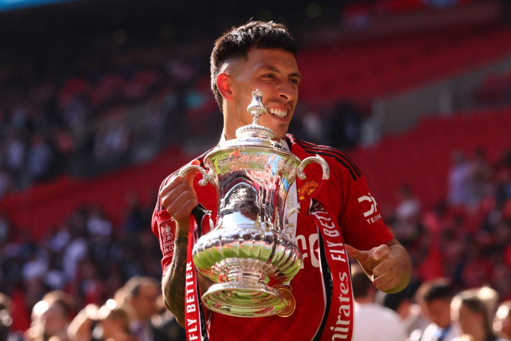 Lisandro Martínez of Manchester United celebrates with the trophy after the Emirates FA Cup Final match between Manchester City and Manchester Unit...