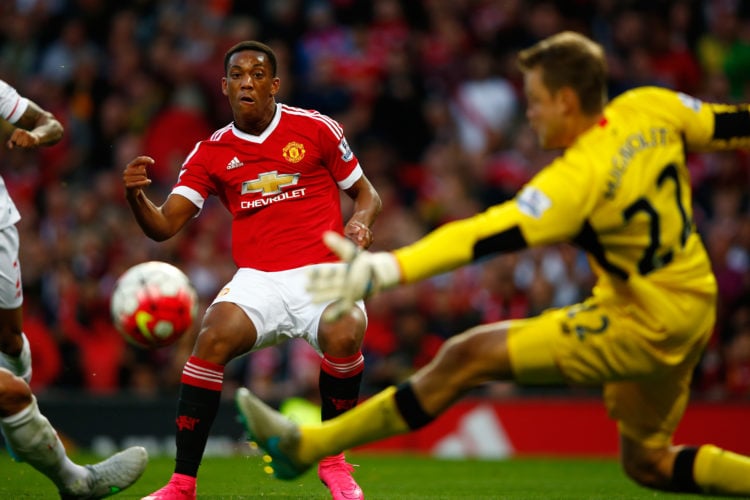 Anthony Martial of Manchester United scores past Simon Mignolet of Liverpool for his team's third goal during the Barclays Premier League match bet...