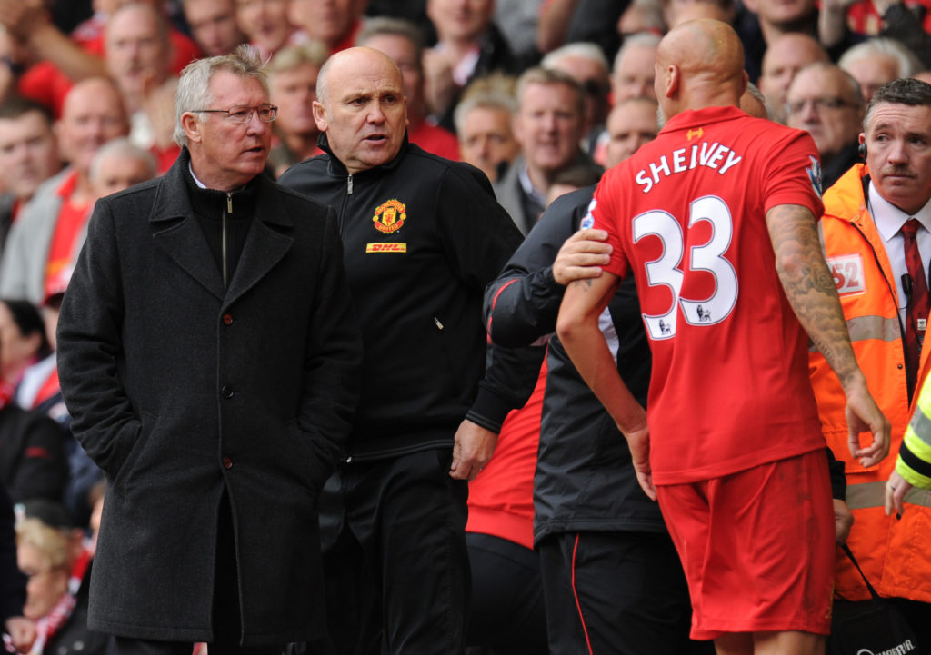 Jonjo Shelvey of Liverpool screams abuse at Sir Alex Ferguson the head coach / manager of Manchester United after being sent off