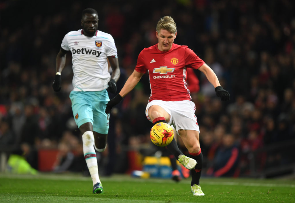 Bastian Schweinsteiger of Manchester United passes ahead of Cheikhou Kouyate of West Ham United during the EFL Cup quarter final match between Manc...