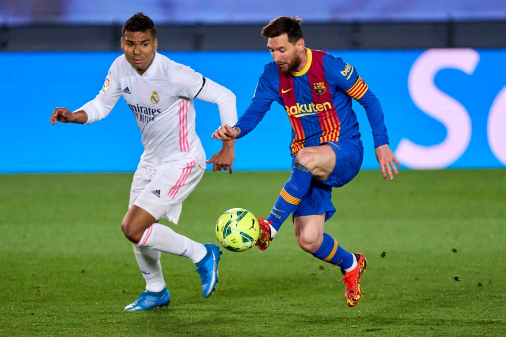 Casemiro of Real Madrid battle for the ball with Lionel Messi of FC Barcelona during the La Liga Santander match between Real Madrid and FC Barcelo...