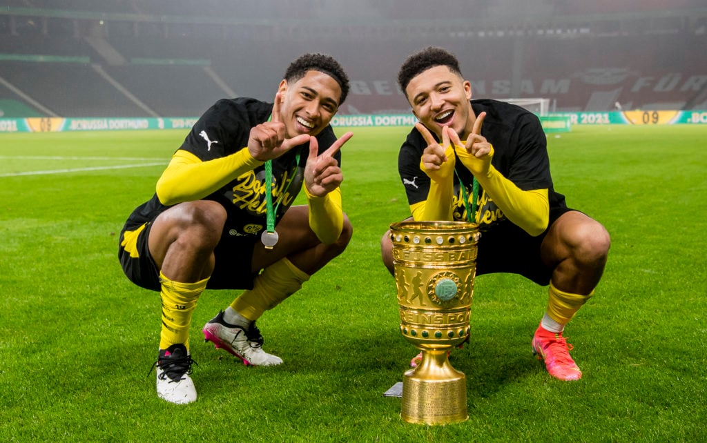 Borussia Dortmund's Jude Bellingham (left) and Jadon Sancho (right) celebrate after the DFB Cup final match between RB Leipzig and Borussia Dortmund at...