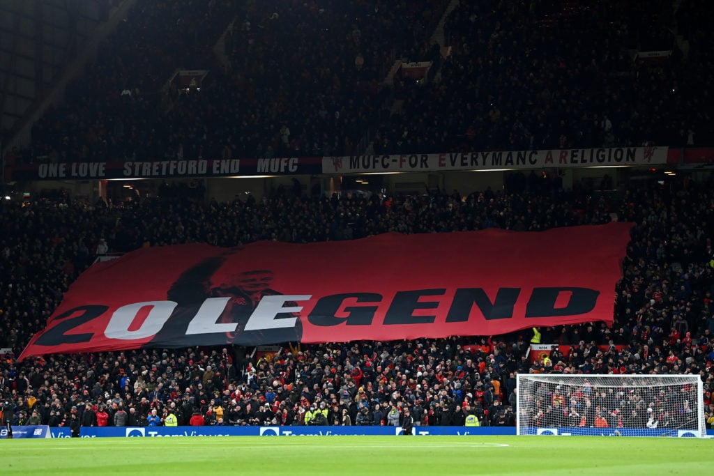 Fans of Manchester United wave a flag in support of Former Player and Manager, Ole Gunnar Solskjaer prior to the Premier League match between Manch...