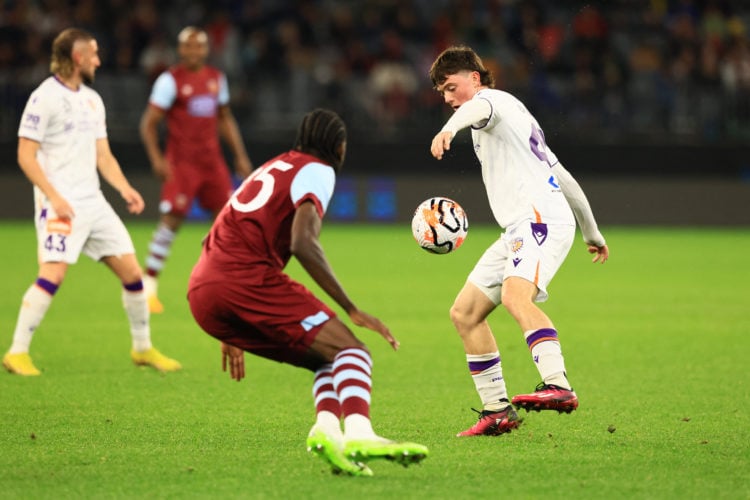 Divin Mubama of West Ham (2R) and James Overy of Perth Glory (R) vie for the ball during an exhibition football match between Perth Glory and West ...