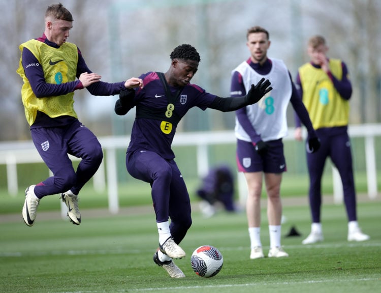 Kobbie Mainoo and Cole Palmer of England battle for possession during a training session at Tottenham Hotspur Training Centre on March 24, 2024 in ...