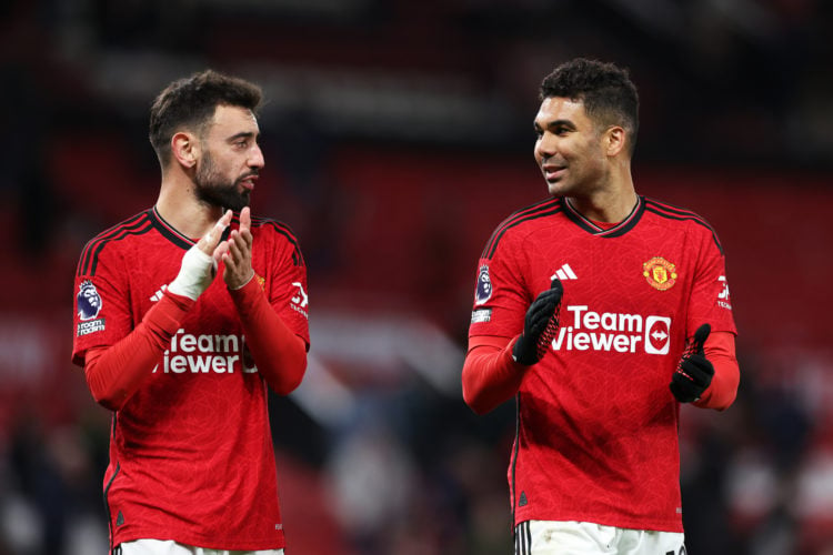 Bruno Fernandes and Casemiro of Manchester United react as they applaud the fans after the team's victory in the Premier League match between Manch...