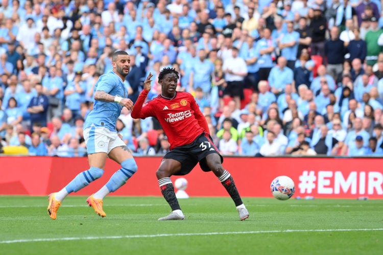 Kobbie Mainoo of Manchester United scores his team's second goal whilst under pressure from Kyle Walker of Manchester City during the Emirates FA C...