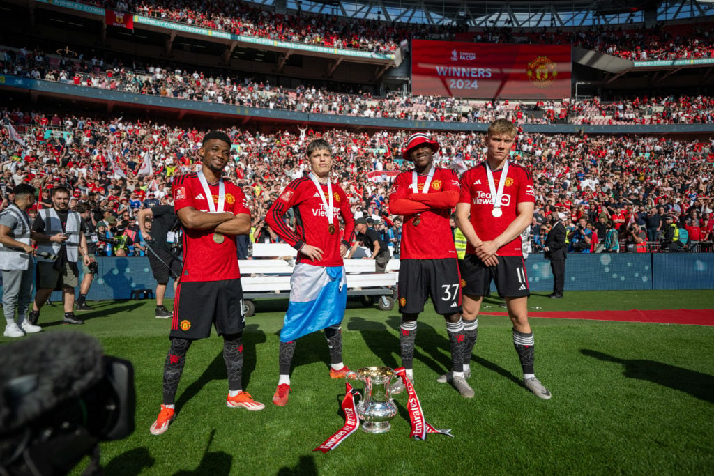 Amad, Alejandro Garnacho, Kobbie Mainoo and Rasmus Hojlund of Manchester United celebrate with the Emirates FA Cup trophy after winning the Emirate...