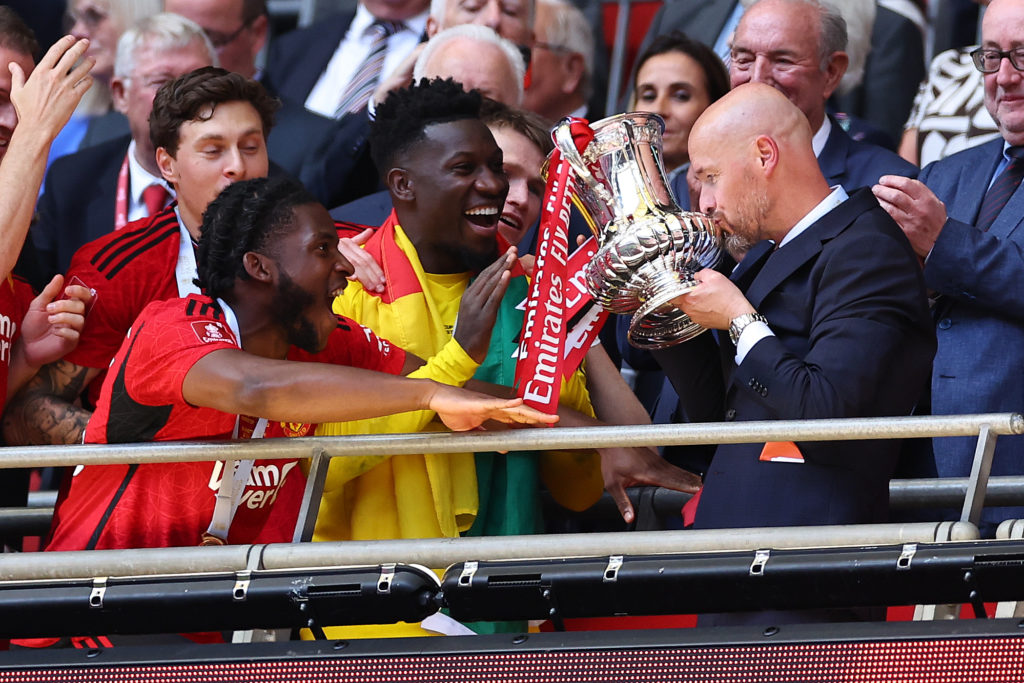 Erik ten Hag the head coach / manager of Manchester United kisses the FA Cup trophy during the Emirates FA Cup Final match between Manchester City ...