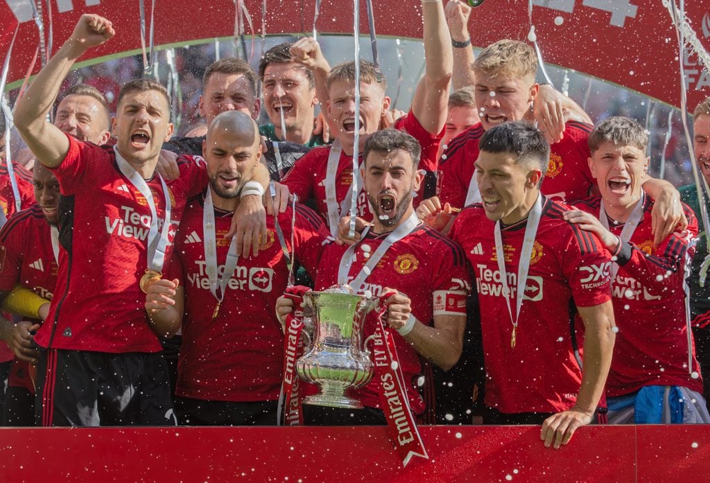 Bruno Fernandes of Manchester United holds aloft the Emirates FA Cup Trophy in celebration with his team mates after winning the 2024 Emirates FA C...