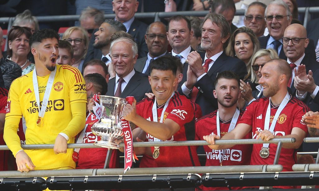 Lisandro Martinez of Manchester United holds aloft the Emirates FA Cup Trophy in celebration after winning the 2024 Emirates FA Cup Final during th...