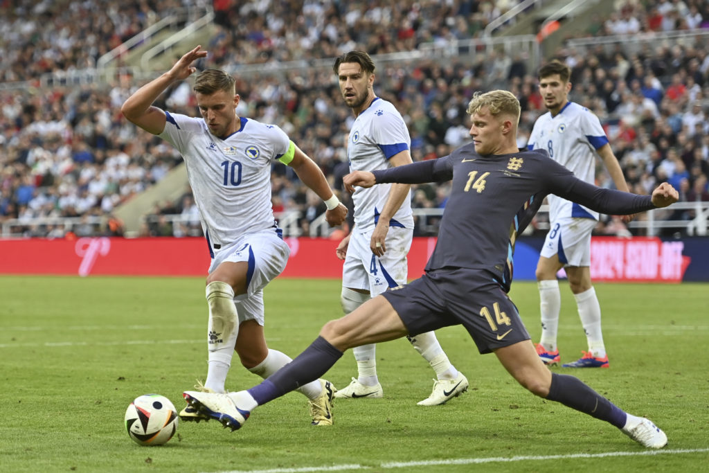 Bosnia and Herzegovina's Ermedin Demirovi (L) and England's Jarrad Branthwaite (R) fight for the ball during the international friendly...