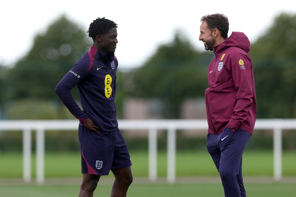 Kobbie Mainoo of England and Gareth Southgate, Manager of England men's senior team, talk during a training session at Spurs Lodge on June 04, 2024...