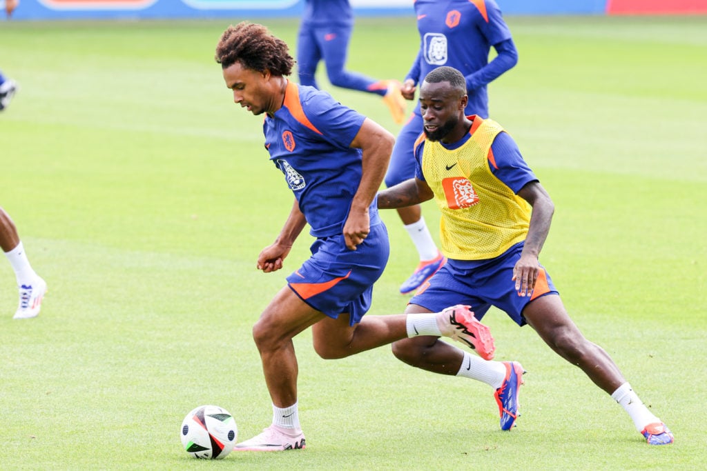 Joshua Zirkzee of the Netherlands battles for possession with Lutsharel Geertruida of the Netherlands during a training session ahead of the group...