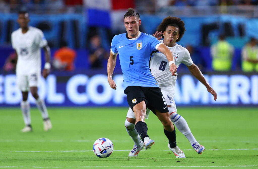 Panama's Adalberto Carrasquilla challenges for the ball with Uruguay's Manuel Ugarte during the CONMEBOL Copa America 2024 Group C match between ...