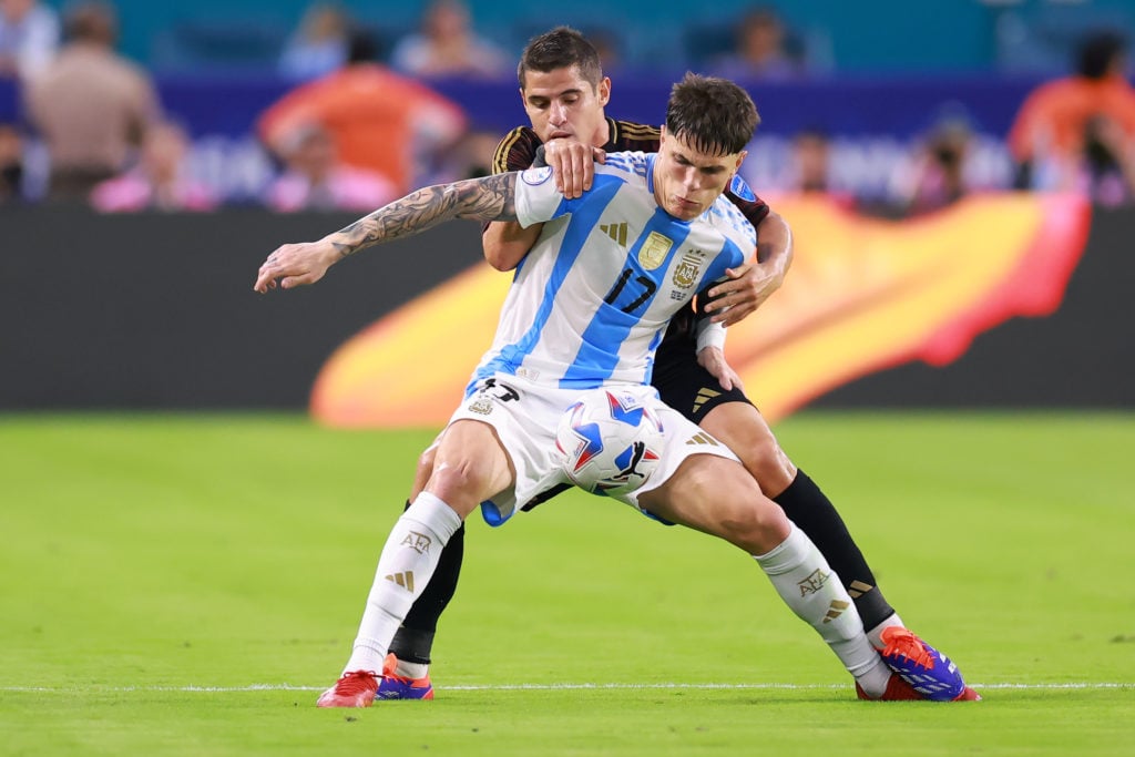 Alejandro Garnacho of Argentina and Aldo Corzo of Peru battle for the ball during the CONMEBOL Copa America 2024 Group A match between Argentina and...