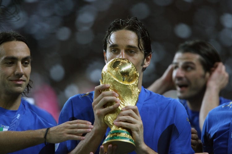 Italian defender Alessandro Nesta, Italian forward Luca Toni and Italian forward Vincenzo Iaquinta celebrate with the trophy after the World Cup 20...