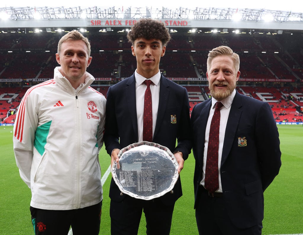 Ethan Wheatley of Manchester United is presented with the Jimmy Murphy Young Player of the Year award by Darren Fletcher and Nick Cox ahead of the ...