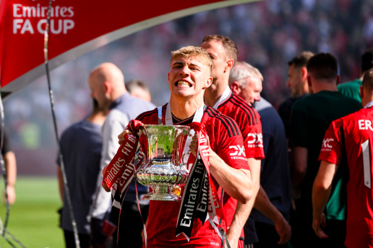 Rasmus Hojlund of Manchester United raises the winners trophy while celebrates with his team and fans after winning Manchester City during the Emir...