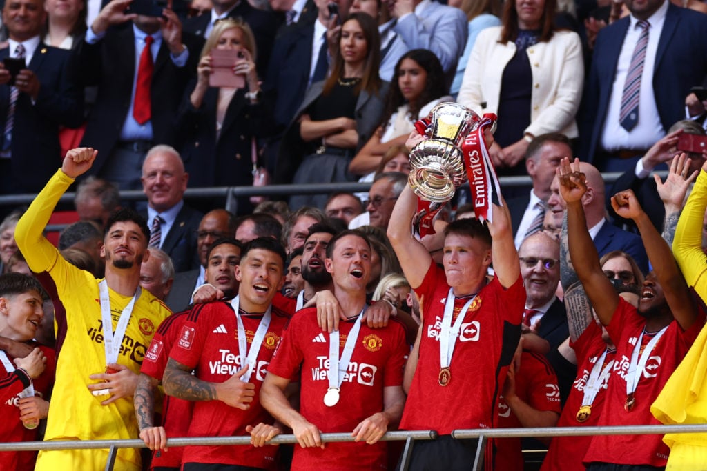 Scott McTominay of Manchester United lifts the trophy among team mates during the Emirates FA Cup Final match between Manchester City and Mancheste...