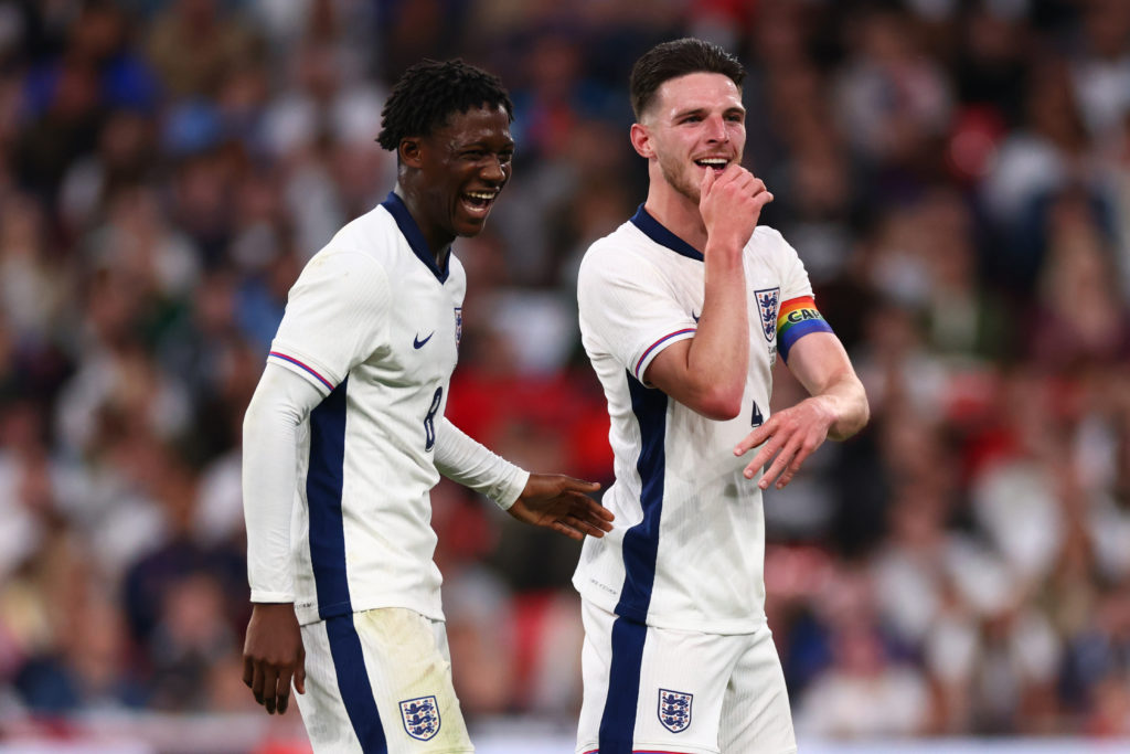 Kobbie Mainoo laughs alongside Declan Rice of England during the international friendly match between England and Iceland at Wembley Stadium on Jun...