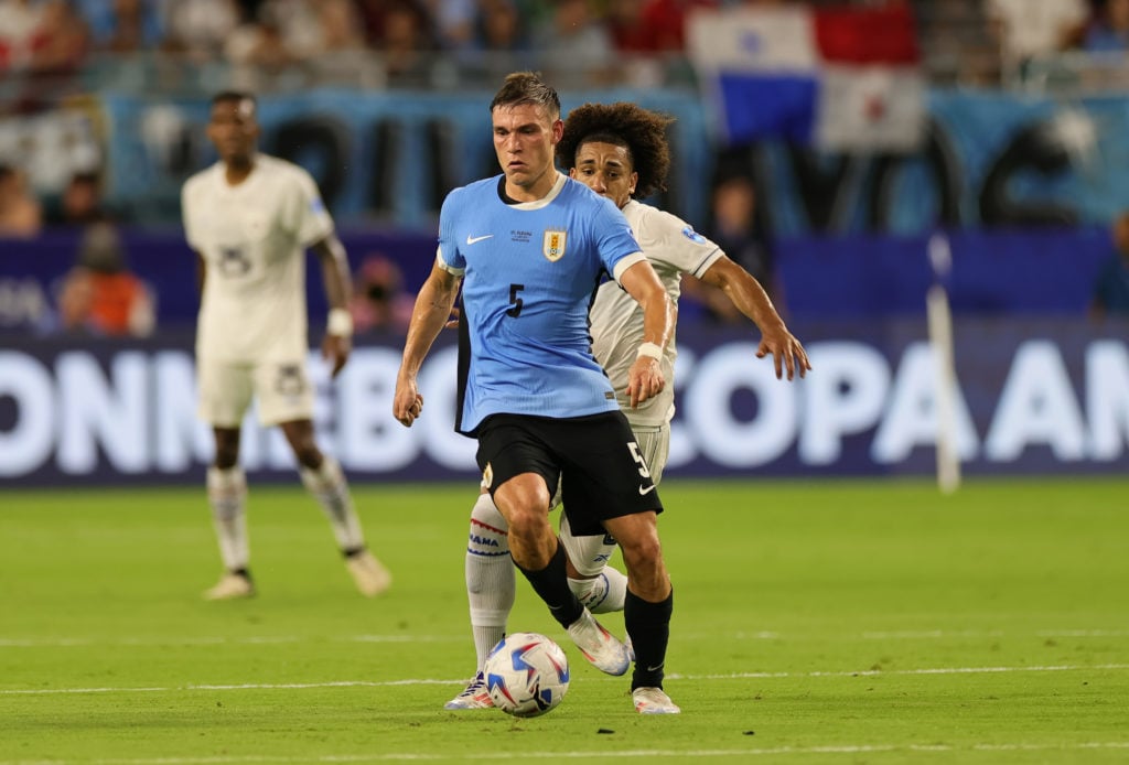 Manuel Ugarte #5 of Uruguay dribbles the ball away from Adalberto Carrasquilla #8 of Panama during the game at Hard Rock Stadium on June 23, 2024.