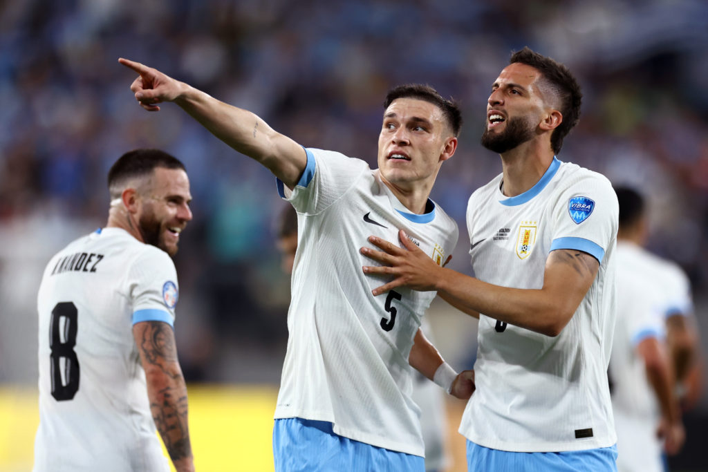 Uruguay's Rodrigo Bentancur (R) celebrates after scoring the team's fifth goal with teammate Manuel Ugarte during the CONMEBOL Copa America 2024 G...