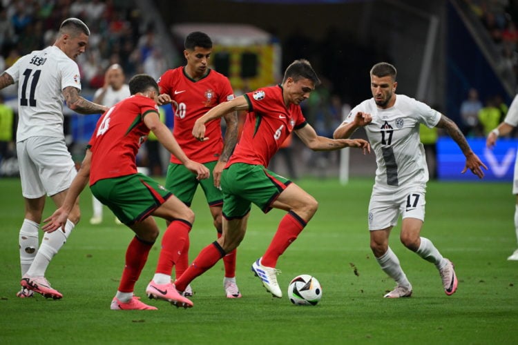 Joao Palhinha (6) of Portugal in action against Jan Mlakar (11) of Slovenia during the UEFA EURO 2024 round of 16 match between Portugal and Sloven...