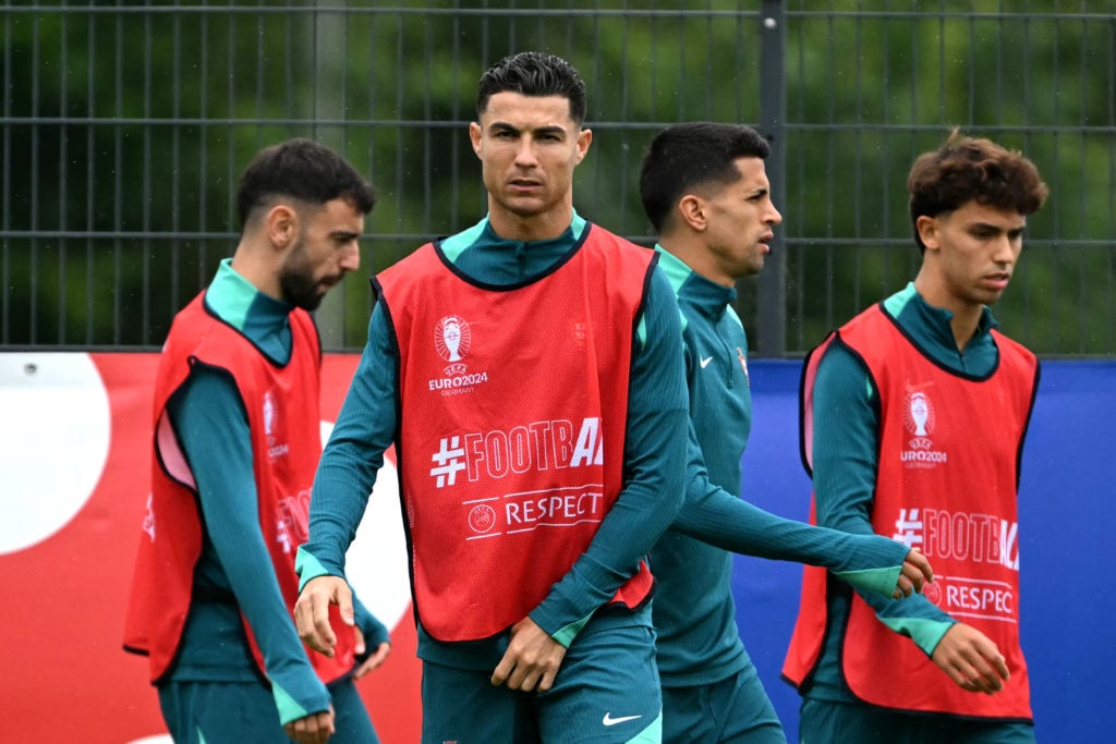 (From L) Portugal's midfielder #10 Bernardo Silva, Portugal's midfielder #08 Bruno Fernandes, Portugal's forward #07 Cristiano Ronaldo, Portugal's ...