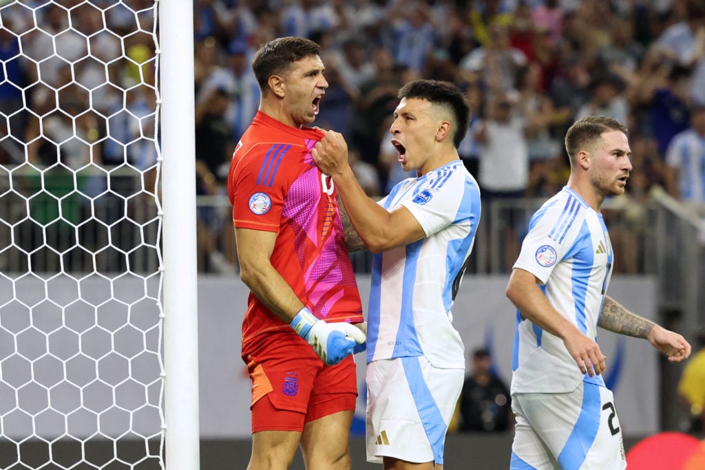 Argentina's goalkeeper #23 Emiliano Martinez (L) celebrates with Argentina's defender #25 Lisandro Martinez  (C) after Ecuador's forward #13 Enner ...