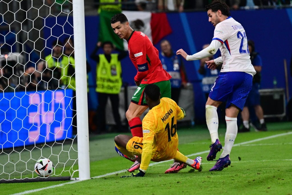 Mike Maignan (16) of France in action against Cristiano Ronaldo (L) of Portugal during the UEFA Euro 2024 round of 16 football match between Portug...