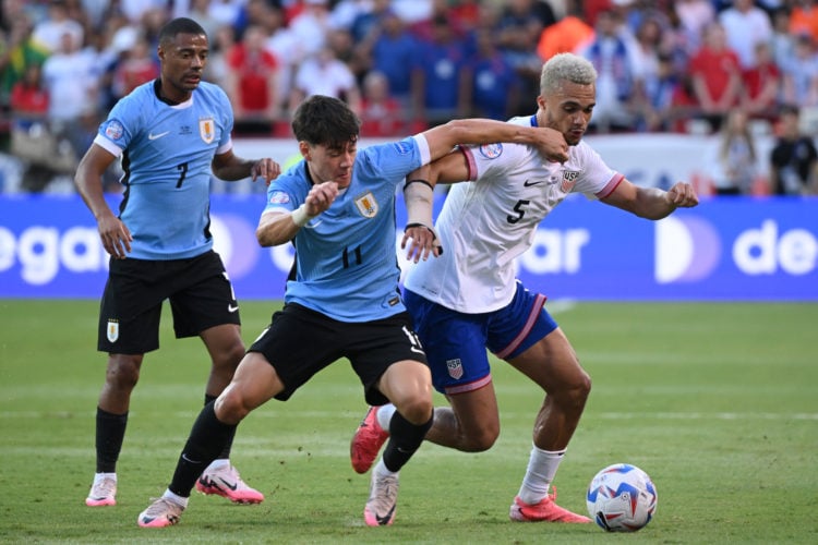 Facundo Pellistri of Uruguay challenges for the ball with Antonee Robinson of United States during the CONMEBOL Copa America 2024 Group C match bet...