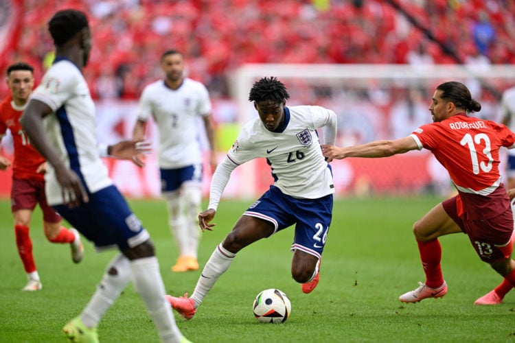 England's midfielder #26 Kobbie Mainoo (C) and Switzerland's defender #13 Ricardo Rodriguez fight for the ball during the UEFA Euro 2024 quarter-fi...