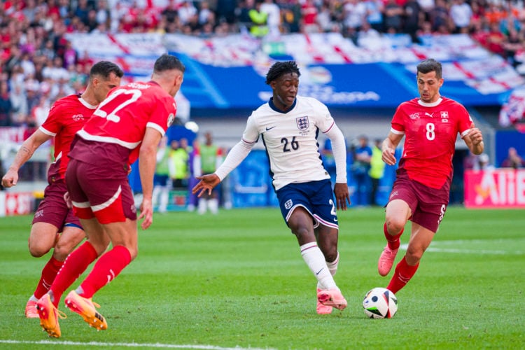 Kobbie Mainoo of England (C) passes the ball during the UEFA EURO 2024 quarter-final match between England and Switzerland at Düsseldorf Arena on J...