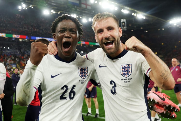 Kobbie Mainoo of England celebrates victory with teammate Luke Shaw after the UEFA EURO 2024 semi-final match between Netherlands and England at Fo...