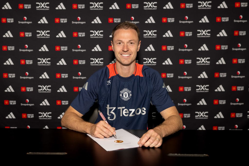 (EXCLUSIVE COVERAGE) Jonny Evans of Manchester United poses after signing a contract extension at Carrington Training Ground on July 12, 2024 in Ma...