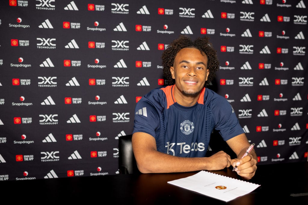 (EXCLUSIVE COVERAGE) Manchester United's Joshua Zirkzee poses after signing for the club at the Carrington Training Ground on July 14, 2024 in Manches...