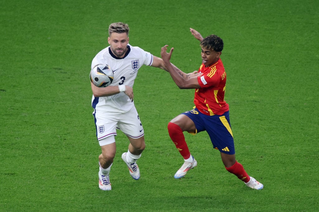 Lamine Yamal of Spain is challenged by Luke Shaw of England during the UEFA EURO 2024 final match between Spain and England at Olympiastadion on Ju...