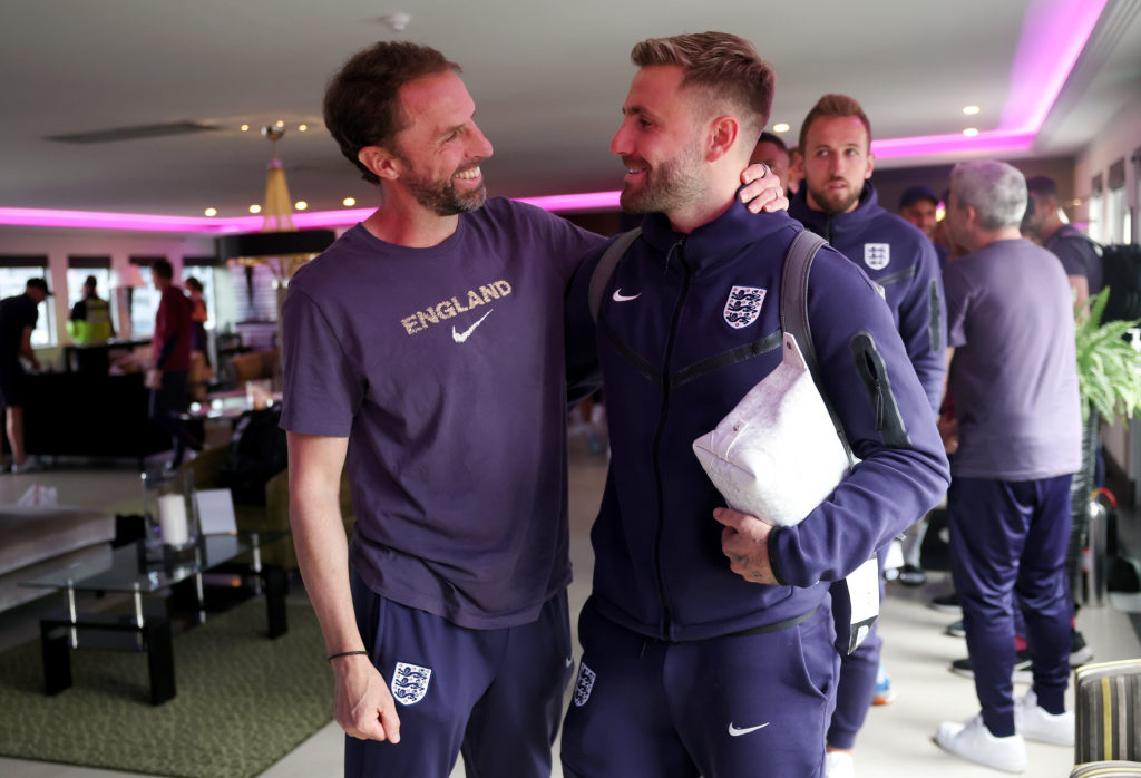 Gareth Southgate, Manager of England men's senior team, and Luke Shaw interact as the England squad arrive at Stansted Airport on July 15, 2024 in...