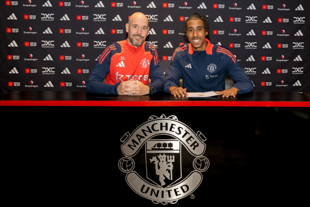 (EXCLUSIVE COVERAGE) Leny Yoro of Manchester United poses with Manager Erik ten Hag after signing for the club at Carrington Training Ground on Jul...